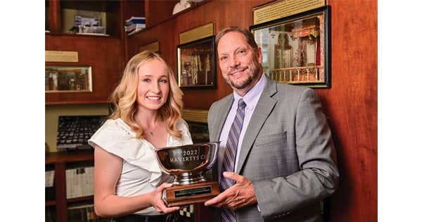 Anna Lomax, left, a Class of 2022 High Point University graduate, was honored as the 2022 recipient of the Haverty Cup by Kirk Holcomb, right, general manager of Havertys. 