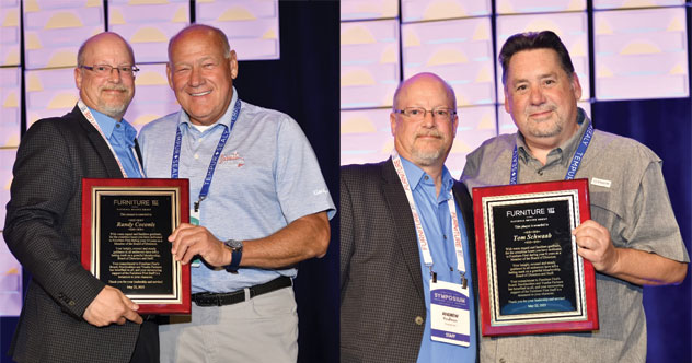 Andrew Kaufman awards Randy Coconis (left) and Tom Schwaab (right) at a general membership meeting before their annual symposium.
