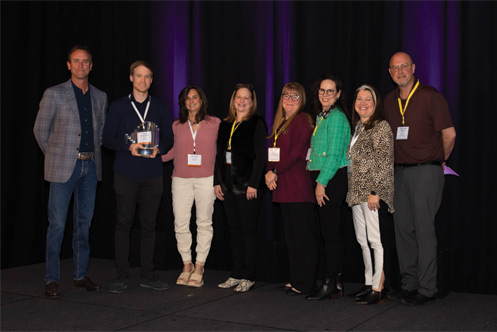 ICFA Chair Erik Mueller, left, presented the 2023 Industry Partner Award to the IMC team including Ryan Mahoney, Jill Ford, Kim McCoy, Heather Hicks, Paula Eller-Cox, Renee Loper-Boyd and Jonathan Papesh.